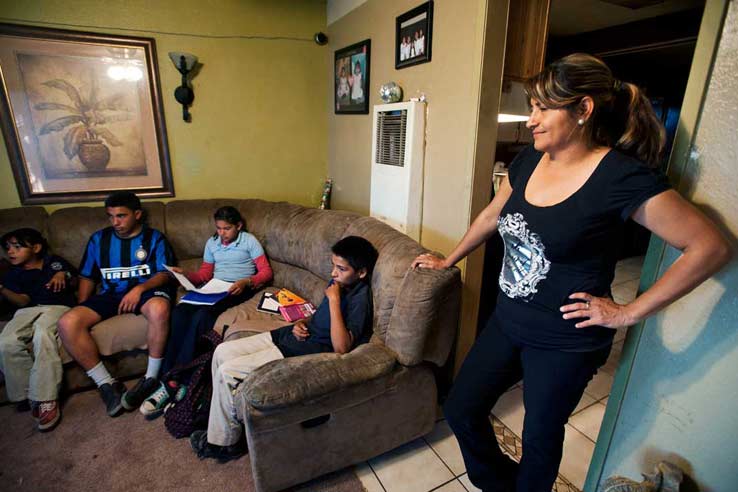 Mother Veronica Reyes watches over four of her five children in their San Bernadino home on Tuesday, Nov. 13, 2012. Twenty five years ago, Reyes her home of Chihuahua, Mexico at age 17.
