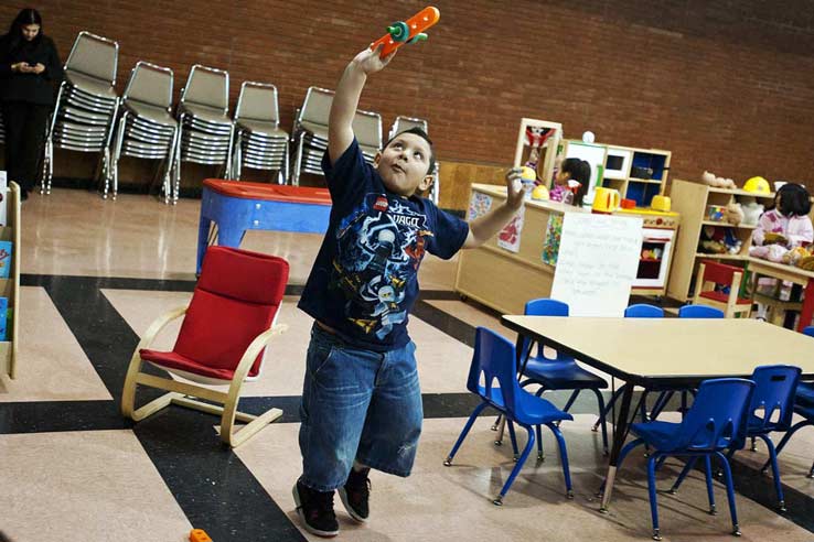 German pretends a toy is flying at East Rio Vista YMCA's free Spanish and English preschool in Highland Park on Thursday morning, Jan. 10.